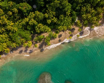Rocky headland framing Batibou Bay’s turquoise water, dominica north coast scenery at the island’s signature beach, Dominica.
