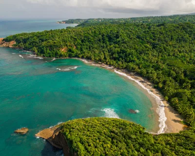 Gentle Atlantic surf washing golden sand at Batibou, a quieter dominica north coast beach scene near Calibishie, Dominica.