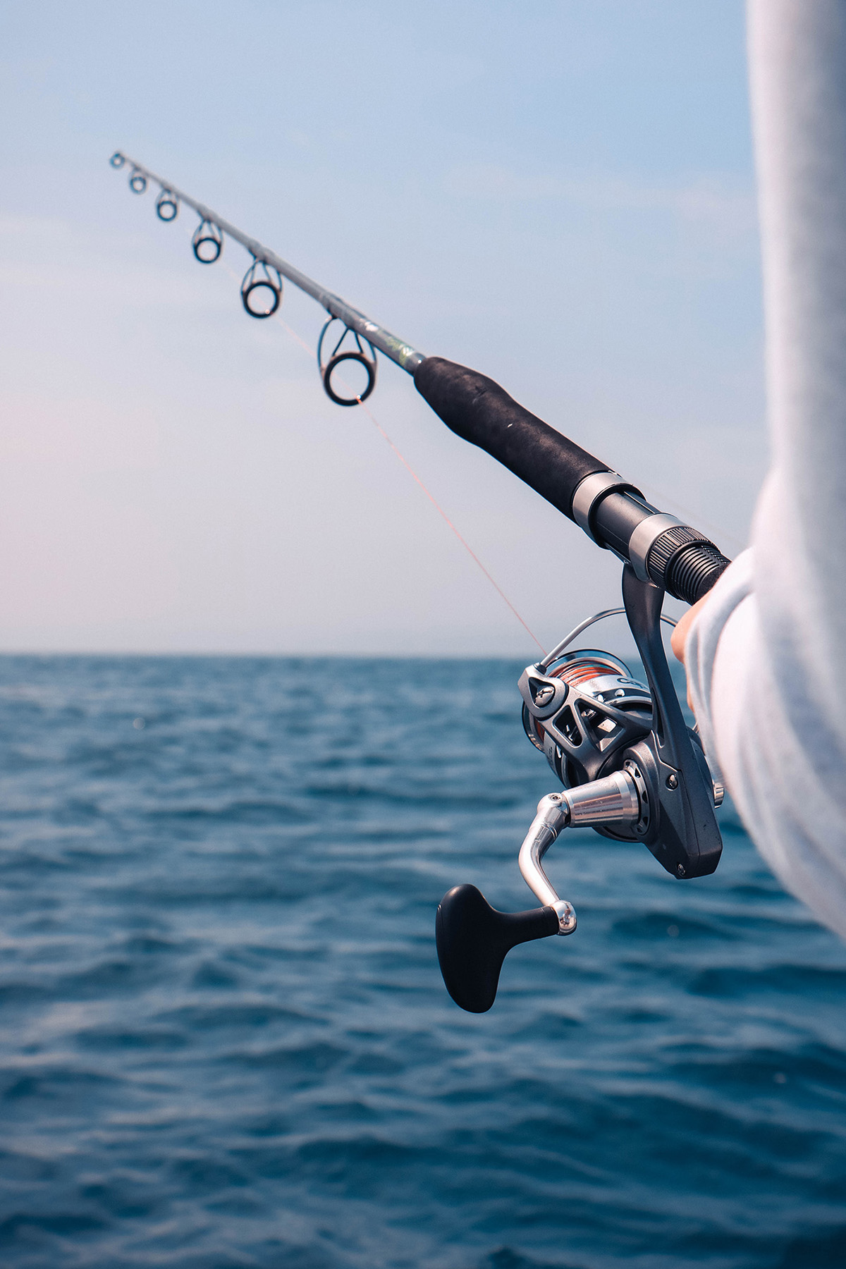 Sport-fishing boat trolling deep blue water beyond Dominica’s leeward coast, sport fishing dominica charters targeting pelagics along volcanic drop-offs.