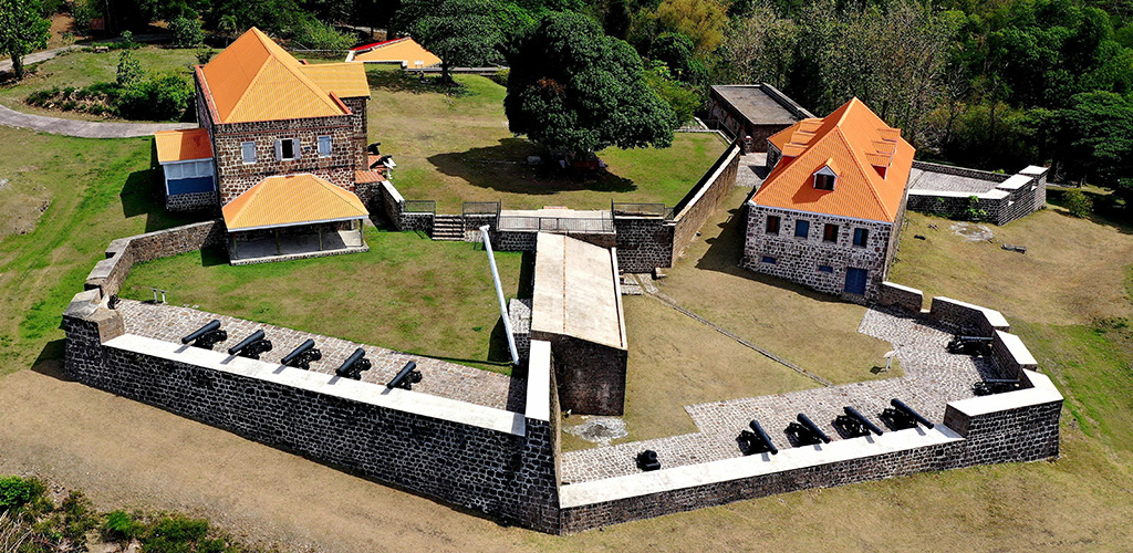 Cannons on stone ramparts of Fort Shirley above Prince Rupert Bay, fort shirley dominica’s restored citadel on Cabrits headland facing the Caribbean, Dominica.