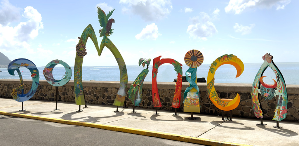 The narrow coastal road along Dominica's leeward west coast — typical driving conditions visitors weigh when asking is dominica safe before renting a car.