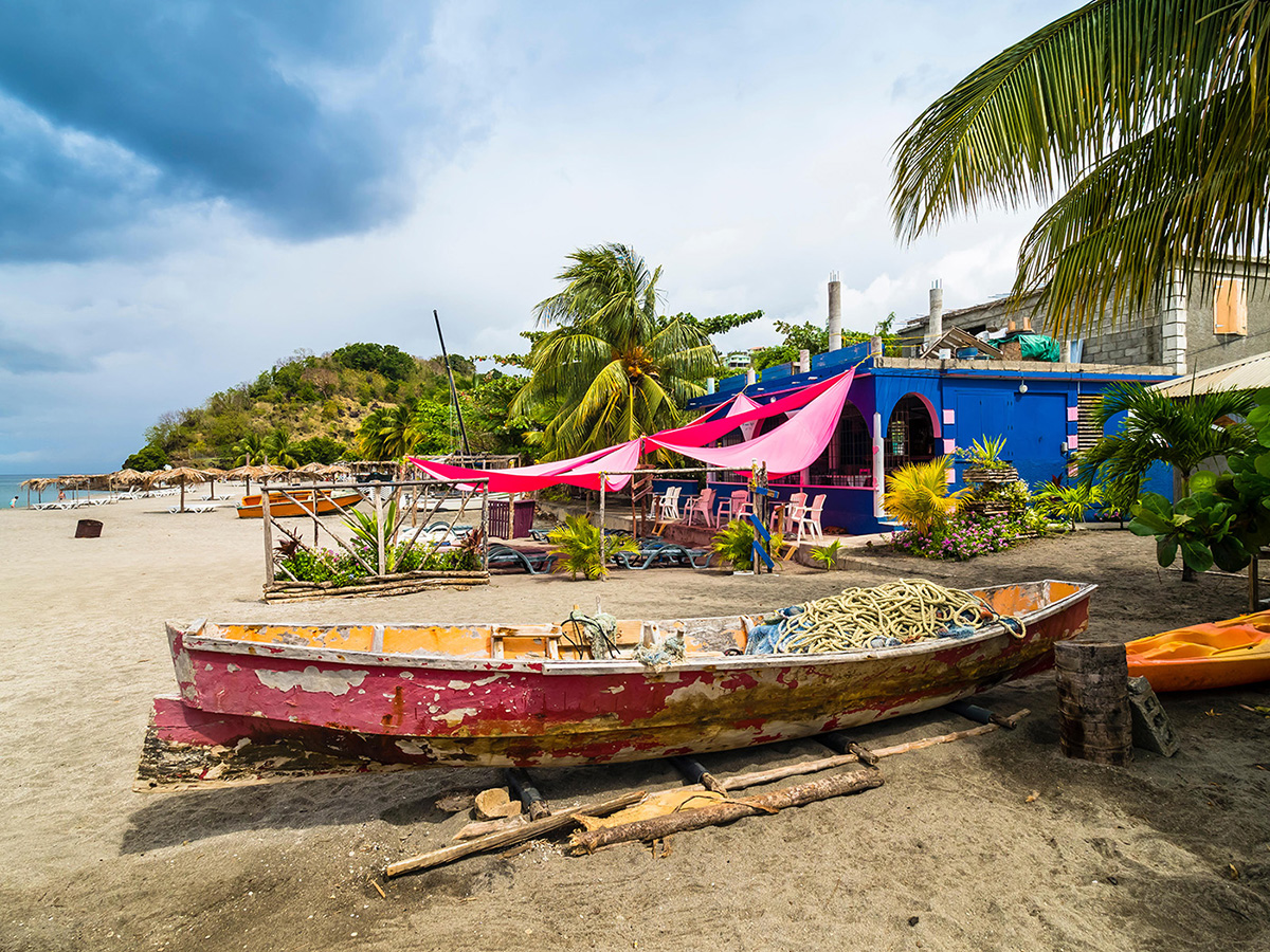 Dark volcanic sand and gentle Caribbean waves at Mero Beach, mero beach dominica’s most convenient swim beach a short drive west of Roseau.
