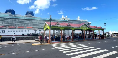 Cruise ship docked at Roseau’s cruise berth with forested ridges behind, dominica cruise port skyline from the waterfront promenade, Dominica.