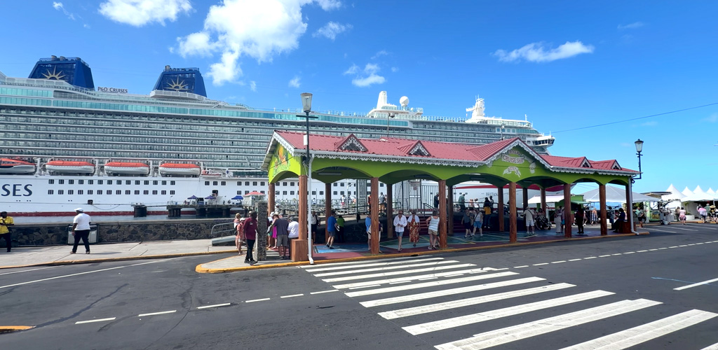 Cruise ship at Roseau's Bay Front berth with colourful low-rise capital and forested ridges — dominica cruise port arrivals stepping onto Nature Island trails.